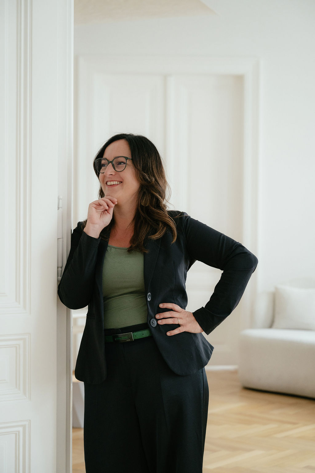 Daniela Reisner, Business-Coach in Altbautür stehend, zur Seite blickend